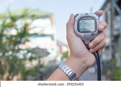 Close Up Of Hand Holding Digital Chronometer