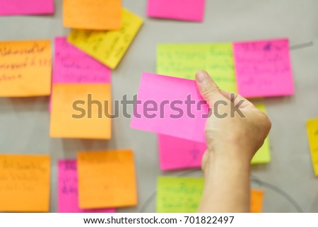 Close up hand holding empty note sticky for brainstorm strategy workshop business.Brainstorming concept.