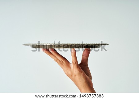 close up of hand holding a empty tray