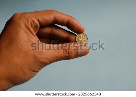 Close up hand holding five cent dollar coin singapore