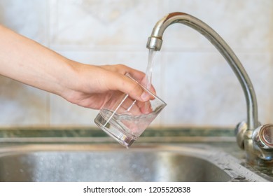 Close Up Hand Holding Glass Fill With Water Pour From Tap