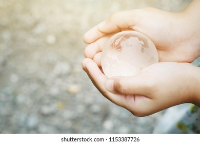close up hand holding glass global with nature copy space background, world ozone day concept, vintage tone