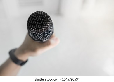 Close Up Of Hand Holding Microphone