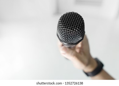 Close Up Of Hand Holding Microphone