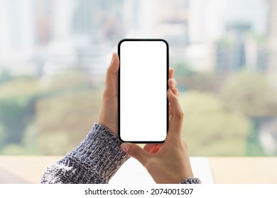 close up hand holding mock-up phone blank screen and cityscape blur background - Shutterstock ID 2074001507