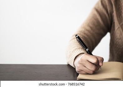 Close up of Hand holding pen, it's like a letter writer. Creative idea of work 2019 goals, writing, drawing,making notes in document.Business,investment,concept,Vintage ,Retro natural mood style.