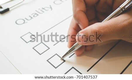 Close- up hand holding pen on quality check paper and the format for filling in information in business concept,vintage style and softtone Stock photo © 