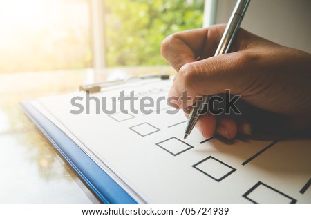 Close- up hand holding pen on check list paper and the format for filling in information in business concept,vintage style and softtone Stock photo © 