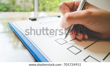 Close- up hand holding pen on check list paper and the format for filling in information in business concept,vintage style and softtone Stock photo © 
