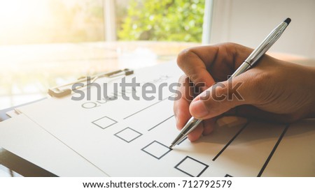 Close- up hand holding pen on quality check paper and the format for filling in information in business concept,vintage style and softtone Stock photo © 
