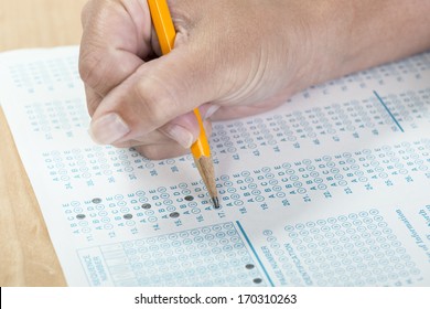 Close Up Of A Hand Holding A Pencil Taking A Standardized Test