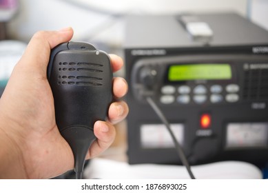 Close Up Of Hand Holding Speaker Ham Radio Transceiver Base Station.