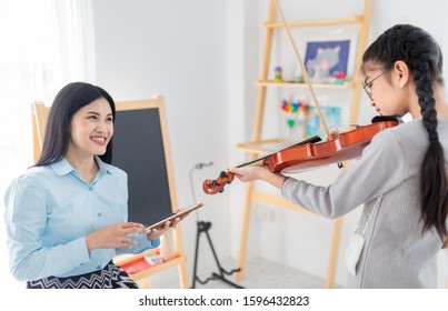 Close Up Hand Holding Violin, Cute Asian Children Playing Violin With. Teacher, She Show Violin Skill And Present Melody And Song To Teacher, They Feeling Happy And Smile