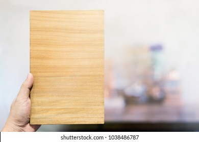 Close up hand holding wood for menu mock up design