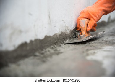 Close Up Hand Labor Hold Trowel Masonry Work In Construction Site