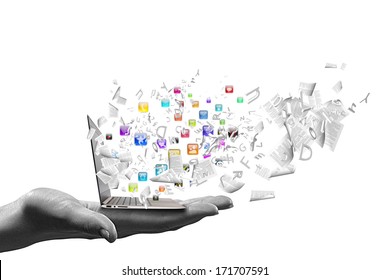 Close up of hand with laptop and media icons Stock Photo