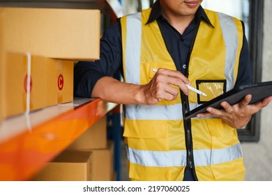 Close up of hand logistic workers are checking and preparing the product parcel cardboard box in warehouse.