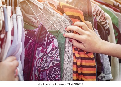 Close Up Of A Hand, Looking On A Flea Market For Clothes.