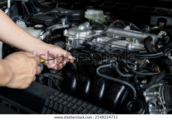Close up hand a man check engine oil\
level in engine room car service and maintenance\
concept