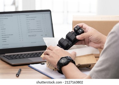 Close up hand a man hold Set of switches for adjusting electric car windows that are taken out of the packaged bag to check the orderliness to be packed into boxes and sent to customers  - Shutterstock ID 2127163802
