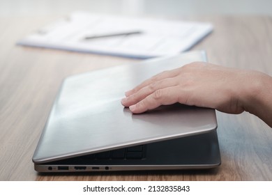 Close Up Hand A Man Close Laptop Cover When The Work Is Finish And Checklist On The Table 