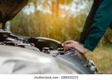 Close Up Hand Man Open Car Hood For Repair As Maintenance Service. Man Trying To Check A Car Engine, Looking Inside Open Bonnet