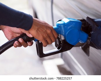 Close Up Hand Of Man Pumping Gasoline Fuel In Car At Gas Station.