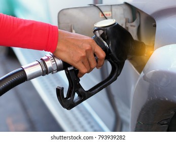 Close Up Hand Of Man Pumping Gasoline Fuel In Car At Gas Station.