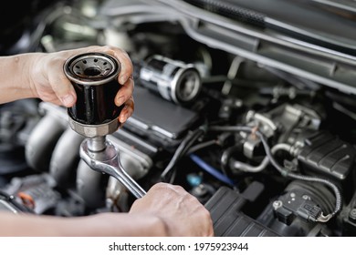 Close Up Hand A Man Take Off Old Oil Filter From Wrench In Hand Man  Old Filter Change In Engine Room Service Concept Of Car