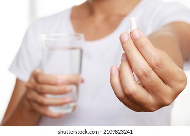 Close Up Hand Man Taking Multiple Pills Take A Medicine In Hand Holding A Cup Glass Of Drinking Water On Wooden Table. Stop Drug Use Taking Medication Health Care Medical Concept.	