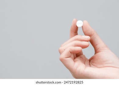 close up hand man taking multiple pills take a medicine in hand holding a cup glass of drinking water on wooden table. Stop drug use Taking Medication health care medical concept.	