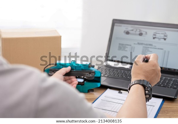 Close up hand a man use pen pointing laptop\
monitor check part in online stock of car brake calliper for\
maintenance work , car service\
concept