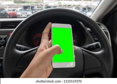 Close Up Hand Man Using Smartphone With Green Screen Driving Car.