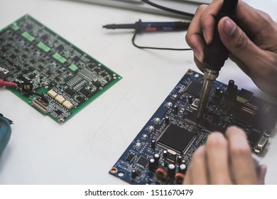 Close up of the hand men hold tool repairs electronics manufacturing Services, Manual Assembly Of Circuit Board Soldering. - Shutterstock ID 1511670479