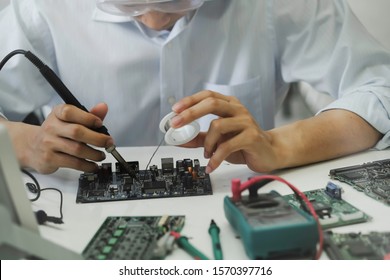 Close up of the hand men hold tool repairs electronics manufacturing Services, Manual Assembly Of Circuit Board Soldering. - Shutterstock ID 1570397716