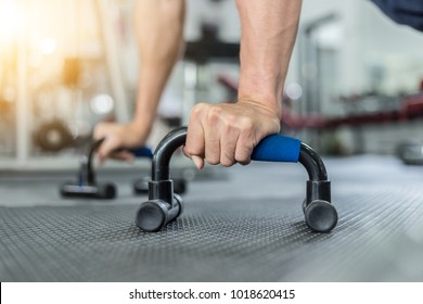 Close Up Hand Of Men Workout With Push Up Bar In Gym,Bodybuilder Concept