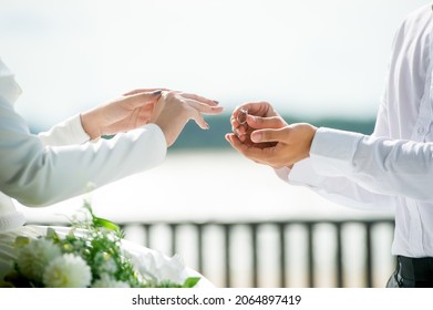 Close Up Hand Muslim Groom In White Dress Waering Wedding Ring To Left Finger Of Muslim Bridge.concept For Wedding Card Background,poster, Invitation Card 