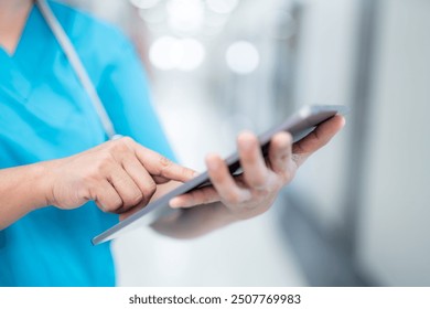 Close up hand of a nurse updating patient treatment plans and medication schedules on a tablet. - Powered by Shutterstock