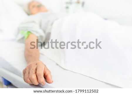 close up hand on bed, palliative care,  old Asian patient sleep on white bed, she feeling lonely, necklace old female, mother's day