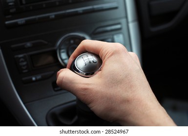 close up of hand on manual gear shift knob