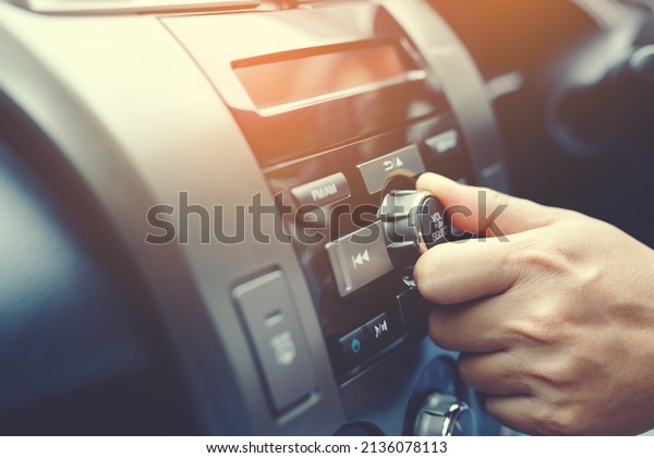 close up hand open car radio listening. Car\
Driver changing turning button Radio Stations on His Vehicle\
Multimedia System. Modern touch screen Audio stereo System.\
transportation and vehicle\
concept