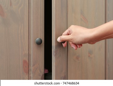 Close Up Hand Open Wooden Cabinet.