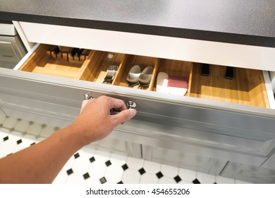 Close Up Of Hand Opening A Grey Drawer In The Kitchen