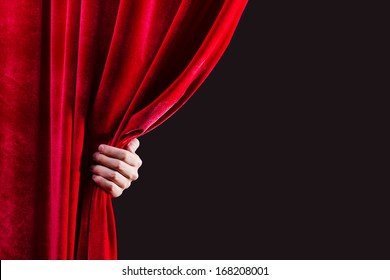 Close Up Of Hand Opening Red Curtain. Place For Text