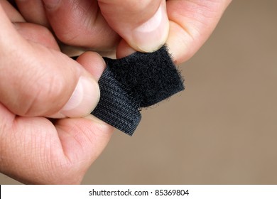 Close up of hand opening a velcro fastener