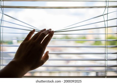 Close Up Hand Opens Jalousie Against The Sunlight Through The Window - Powered by Shutterstock