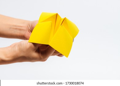 Close Up Of Hand In A Paper Fortune Teller Isolated On White Background.