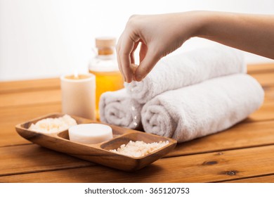 close up of hand with pink salt and bath stuff - Powered by Shutterstock