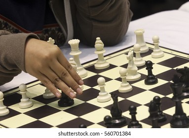 Close up hand playing chess 