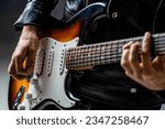 Close up hand playing electric guitar. Musician playing guitar, live music. Man playing guitar. Musical instrument. Electric guitar. Repetition of rock music band.